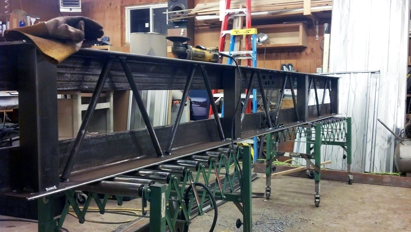 Metal fabrication for repurposing: A newly constructed metal frame for a commercial property renovation is shown in a workshop setting, highlighting the custom metalwork involved in revitalizing the space.